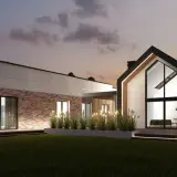 Nowoczesny dom z cegły i betonu z dużymi oknami, oświetlony wieczorem.